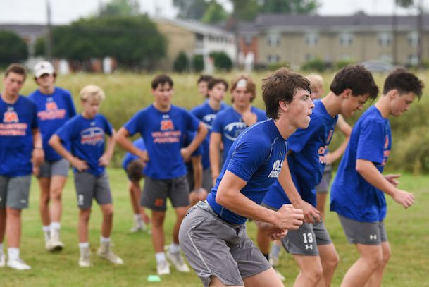 Several local schools begin summer workouts as questions about season linger