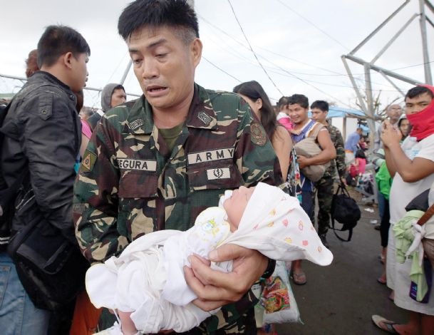 Looting, gunfire break out in typhoon-hit city