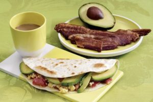 Mix cheesy eggs and ripe avocado for a yummy breakfast taco