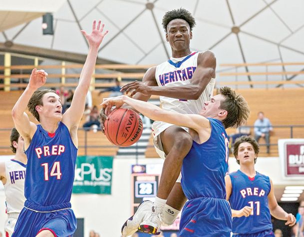 Photos: Heritage Academy boys advance; Caledonia boys fall