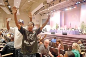 Protests, anger, doubt prevail at Ferguson meeting