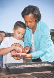 Military kids and 4-H put green thumbs to work in garden