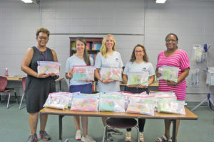 Education: Junior Auxiliary members deliver 1,600 school supply bags to local elementary schools