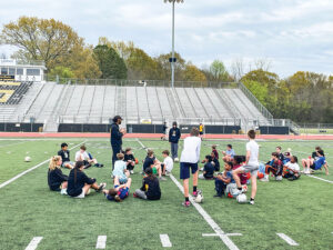 SHS soccer players assist with Intercession soccer camp