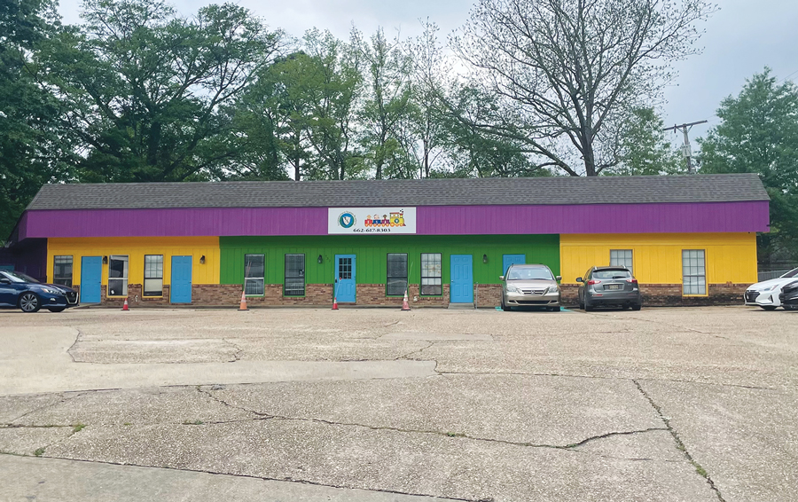 Day care can keep purple awning, must repaint outside walls
